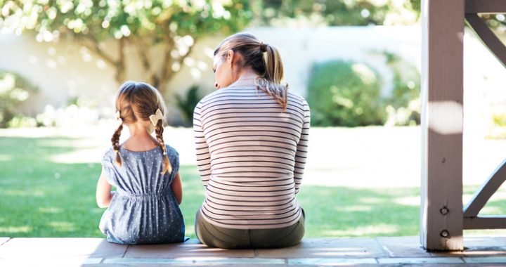 Rearview shot of a young woman and her daughter having a conversation on the porch